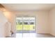 Open living room featuring tile floors, staircase, and backyard views at 33063 Tulip Petal Ln, Wesley Chapel, FL 33545