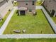 Aerial view of the fenced backyard, featuring a lush lawn and outdoor seating, providing an inviting space at 36412 Garden Wall Way, Zephyrhills, FL 33541