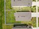 Aerial view shows a fenced backyard with green grass and patio furniture at 36412 Garden Wall Way, Zephyrhills, FL 33541