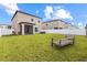 Spacious backyard with healthy lawn, white fence, and screened-in porch is perfect for relaxation and recreation at 36412 Garden Wall Way, Zephyrhills, FL 33541