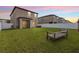 Wide backyard with a well-kept lawn, white fence, and screened-in porch is perfect for relaxation and recreation at 36412 Garden Wall Way, Zephyrhills, FL 33541
