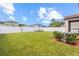Well-maintained lawn, white vinyl fence, and lush greenery, offering a private and serene outdoor space at 36412 Garden Wall Way, Zephyrhills, FL 33541
