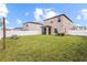 Expansive backyard features a well-maintained lawn, white vinyl fence, and screened-in porch, perfect for outdoor living at 36412 Garden Wall Way, Zephyrhills, FL 33541