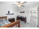 Cozy bedroom featuring a ceiling fan, wooden desk, and decorative wall art at 36412 Garden Wall Way, Zephyrhills, FL 33541