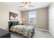 Inviting bedroom featuring a ceiling fan, a window with blinds, and a closet at 36412 Garden Wall Way, Zephyrhills, FL 33541