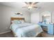 Comfortable bedroom featuring a ceiling fan and a blue desk with stylish accents at 36412 Garden Wall Way, Zephyrhills, FL 33541