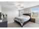 Cozy bedroom with neutral paint, ceiling fan, and natural light at 36412 Garden Wall Way, Zephyrhills, FL 33541
