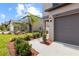 Two-story home with a two-car garage featuring manicured landscaping and a walkway at 36412 Garden Wall Way, Zephyrhills, FL 33541