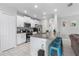Bright kitchen featuring white cabinetry, stainless appliances, and an island with bar seating at 36412 Garden Wall Way, Zephyrhills, FL 33541