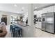 Well-equipped kitchen with sleek stainless steel appliances and granite countertops with bar seating at 36412 Garden Wall Way, Zephyrhills, FL 33541