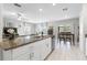Open kitchen boasts granite countertops, stainless steel appliances, and overlooks the living area at 36412 Garden Wall Way, Zephyrhills, FL 33541