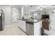 Modern open-concept kitchen with granite countertops and stainless steel dishwasher at 36412 Garden Wall Way, Zephyrhills, FL 33541