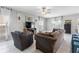 Comfortable living room with bright windows, a ceiling fan, and neutral paint tones at 36412 Garden Wall Way, Zephyrhills, FL 33541