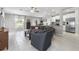Open concept living room and kitchen area with modern stainless steel appliances at 36412 Garden Wall Way, Zephyrhills, FL 33541
