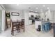 Spacious living and kitchen area with a modern design and an eat-in dining table at 36412 Garden Wall Way, Zephyrhills, FL 33541