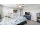 Spacious main bedroom featuring a ceiling fan, natural light, and ample closet space at 36412 Garden Wall Way, Zephyrhills, FL 33541