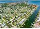 Expansive aerial shot showcases a neighborhood with canals and houses with boat docks, with ocean views at 3944 49Th S Ave, St Petersburg, FL 33711
