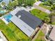 Home featuring a backyard with a screened-in patio/sunroom and pool, lush landscaping, and a large backyard with green grass at 3944 49Th S Ave, St Petersburg, FL 33711