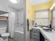 Bright bathroom featuring a shower-tub combination and a unique vessel sink with modern fixtures at 3944 49Th S Ave, St Petersburg, FL 33711