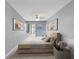 Cozy bedroom featuring neutral decor, modern art, and sliding glass door to outdoor area at 3944 49Th S Ave, St Petersburg, FL 33711