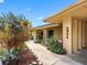 Exterior detail showing lush landscaping and front entrance near the covered carport at 3944 49Th S Ave, St Petersburg, FL 33711