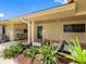Inviting home exterior featuring a covered porch, colorful seating, and lush landscaping at 3944 49Th S Ave, St Petersburg, FL 33711
