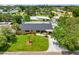 Well-maintained home featuring lush green lawn, mature trees, and landscaping creating a picturesque curb appeal at 3944 49Th S Ave, St Petersburg, FL 33711