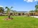 Charming home with a lush lawn, a mature palm tree, and a covered porch, showcasing inviting curb appeal at 3944 49Th S Ave, St Petersburg, FL 33711