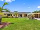 Charming single-story home with lush lawn, mature palms, and a convenient covered carport at 3944 49Th S Ave, St Petersburg, FL 33711