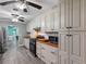 Spacious kitchen with bright cabinets, butcher block counters, modern appliances, and gray wood-look floors at 3944 49Th S Ave, St Petersburg, FL 33711