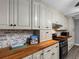 Bright kitchen featuring custom cabinets, butcher block countertops, and modern appliances at 3944 49Th S Ave, St Petersburg, FL 33711