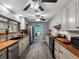 A bright, updated kitchen with butcher block counters, stainless appliances, and wood-look floors at 3944 49Th S Ave, St Petersburg, FL 33711