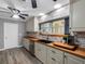 Well-lit kitchen featuring custom cabinets, butcher block countertops, and stainless steel dishwasher at 3944 49Th S Ave, St Petersburg, FL 33711
