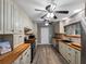 An updated kitchen with butcher block countertops, stainless appliances, and modern light gray wood floors at 3944 49Th S Ave, St Petersburg, FL 33711