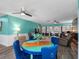 Open concept living area featuring sleek flooring, ceiling fans, and comfortable seating at 3944 49Th S Ave, St Petersburg, FL 33711