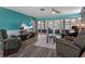 Comfortable living room with a large TV and access to a screened outdoor patio at 3944 49Th S Ave, St Petersburg, FL 33711
