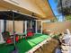 A serene outdoor patio featuring a small pond and comfortable seating under a sun umbrella at 3944 49Th S Ave, St Petersburg, FL 33711