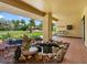 Covered outdoor patio featuring a rock pond, comfortable seating, tile flooring, and serene views of the front yard at 3944 49Th S Ave, St Petersburg, FL 33711