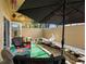 Outdoor patio with decorative pond, covered seating area, and privacy wall at 3944 49Th S Ave, St Petersburg, FL 33711