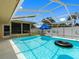 Enclosed pool with a blue umbrella, providing a private and inviting outdoor space for relaxation at 3944 49Th S Ave, St Petersburg, FL 33711