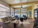 Inviting sunroom with cozy seating, tile floors, and large windows overlooking the pool and yard at 3944 49Th S Ave, St Petersburg, FL 33711