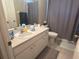 Bathroom features a single sink with vanity and a toilet with grey shower curtain at 4436 Horseshoe Pick Ln, Valrico, FL 33594