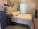 Bright bedroom featuring a comfortable bed, shelves with decor, dresser, and mirror at 4436 Horseshoe Pick Ln, Valrico, FL 33594