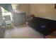 Bedroom featuring a casual sofa, dresser, and window for comfort and storage at 4436 Horseshoe Pick Ln, Valrico, FL 33594