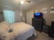 Bright bedroom featuring a comfortable bed, closet, dresser, and decor at 4436 Horseshoe Pick Ln, Valrico, FL 33594