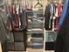 Organized closet with clothes, shelving, and storage cubes for optimal storage at 4436 Horseshoe Pick Ln, Valrico, FL 33594