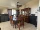 Elegant dining room featuring a classic wooden dining set, a large hutch, and neutral tile flooring at 4436 Horseshoe Pick Ln, Valrico, FL 33594