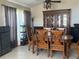 Inviting dining room with a wooden table set, decorative china cabinet, tile flooring, and a large ceiling fan at 4436 Horseshoe Pick Ln, Valrico, FL 33594