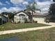 Beautiful single-story home featuring a well-manicured lawn, mature landscaping, and a two-car garage at 4436 Horseshoe Pick Ln, Valrico, FL 33594
