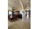 Hallway with tile flooring connects the dining area to the front of the house, showcasing natural light at 4436 Horseshoe Pick Ln, Valrico, FL 33594